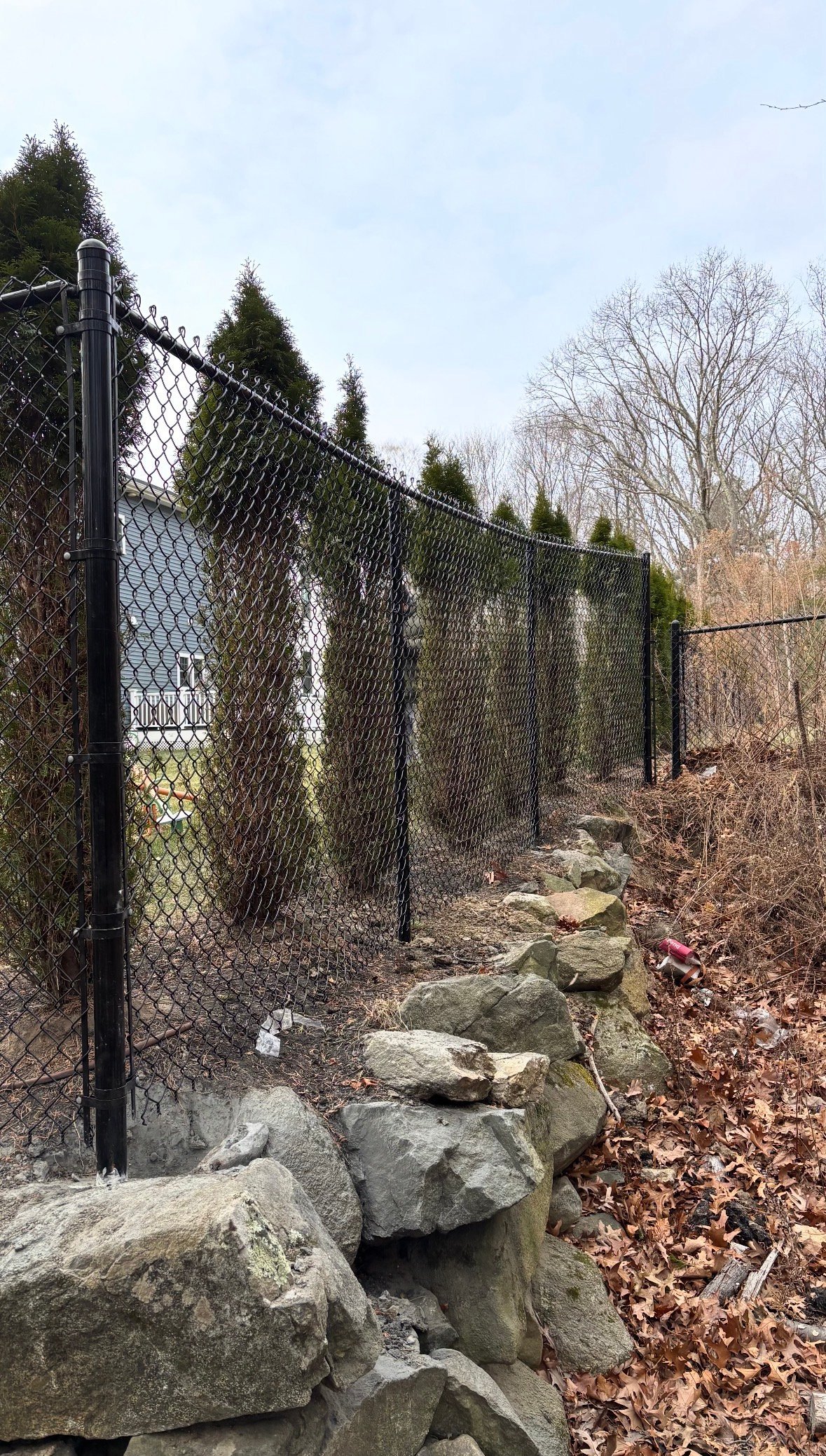 Chain Link Fencing — Durable black chain link fencing installed secure and level — perfect for property lines, yards and commercial enclosures.